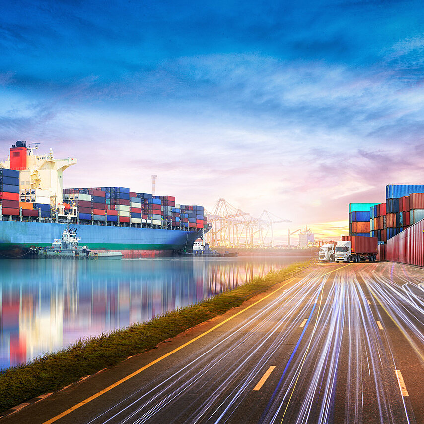 Transportschiff mit Containern am belebten Umschlaghafen